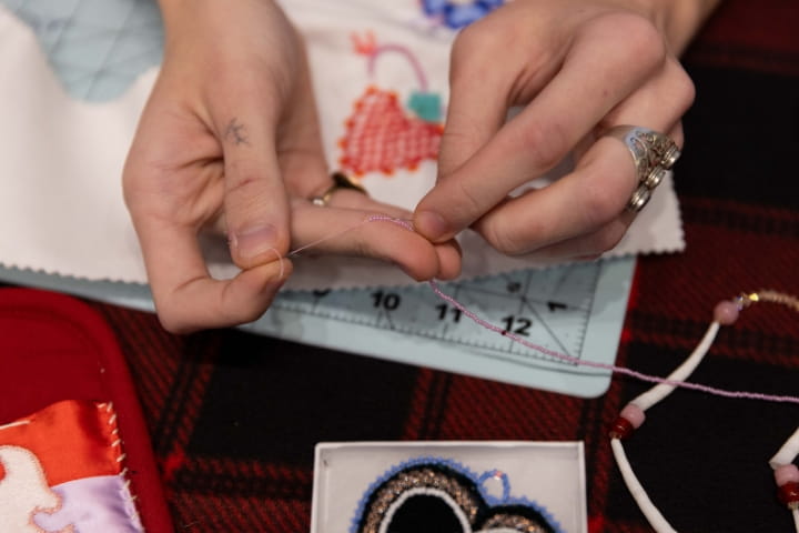 hands doing beadwork