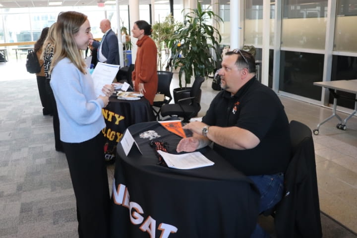 student talking to vendor