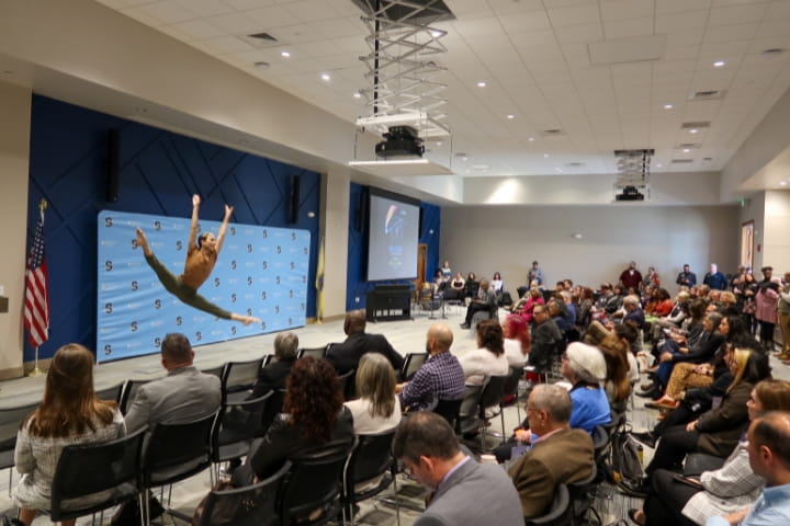 Sophomore Jackson O'Brien performs on stage for audience 