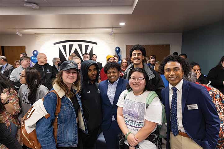 A group of students smiling in the Multicultural Center