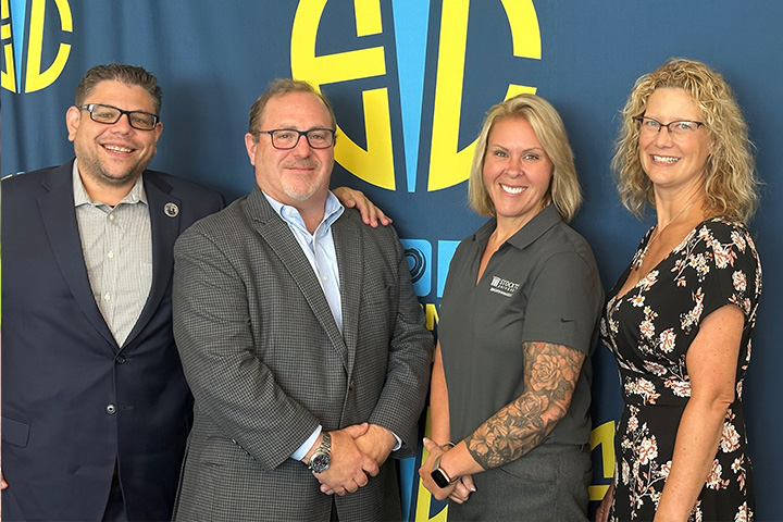 Demetrios Roubos, David Weinstein, Noel Criscione-Naylor and Jennifer Aarons in front of the Esports Innovation Center step and repeat