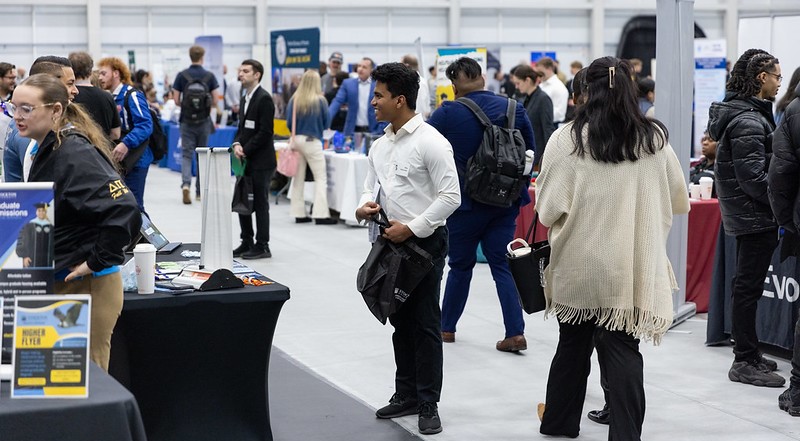 Students meeting an empoyeer at the career fair