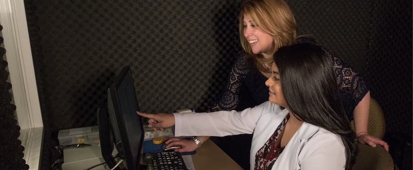 student and instructor in a lab