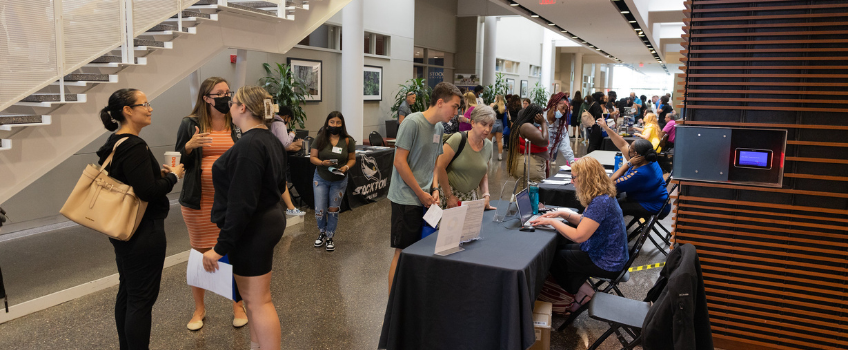 Students and family members ask questions at a New Student Orientation Resource Fair 