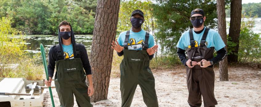 Students with waterproof overpants ready to get in the river