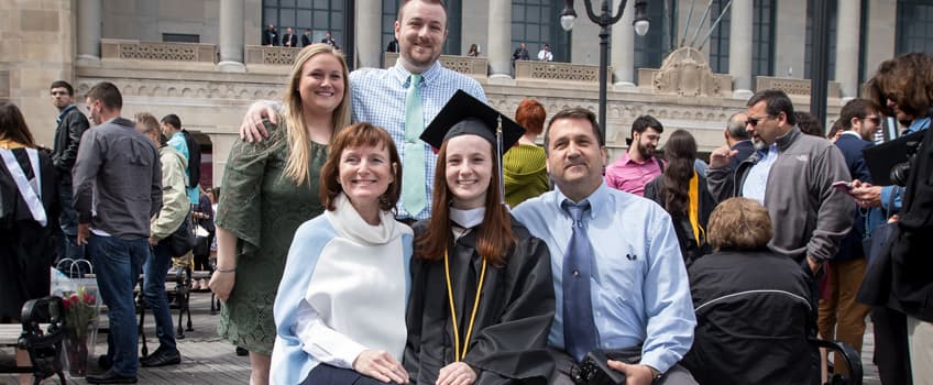 Family with their student at graduation.