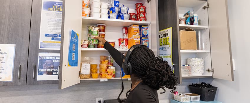 Stockton first-year student Calista Faucette looks over the Pop-Up Pantry in the Women's Gender and Sexuality Center