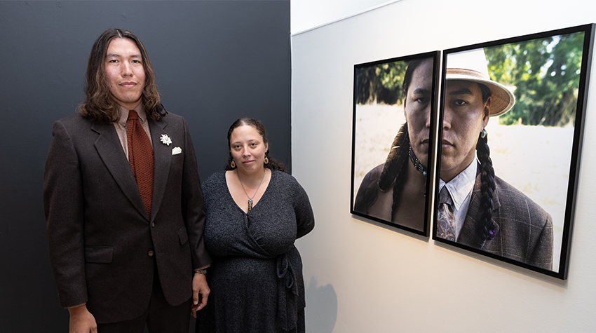 Brittany Johnson and her portrait subject in front of her piece, "Identity."