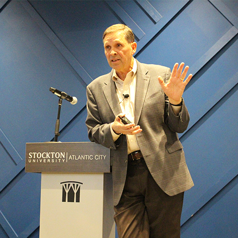 William R. Hagaman, '79 graduate, speaking to students at a podium 