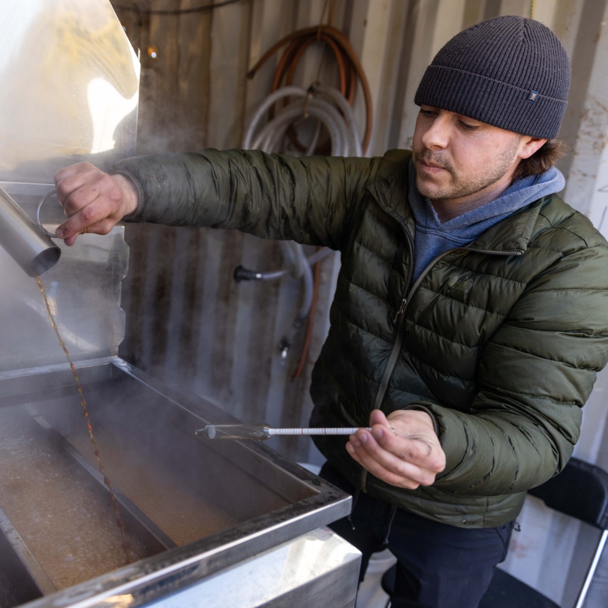 man making maple syrup