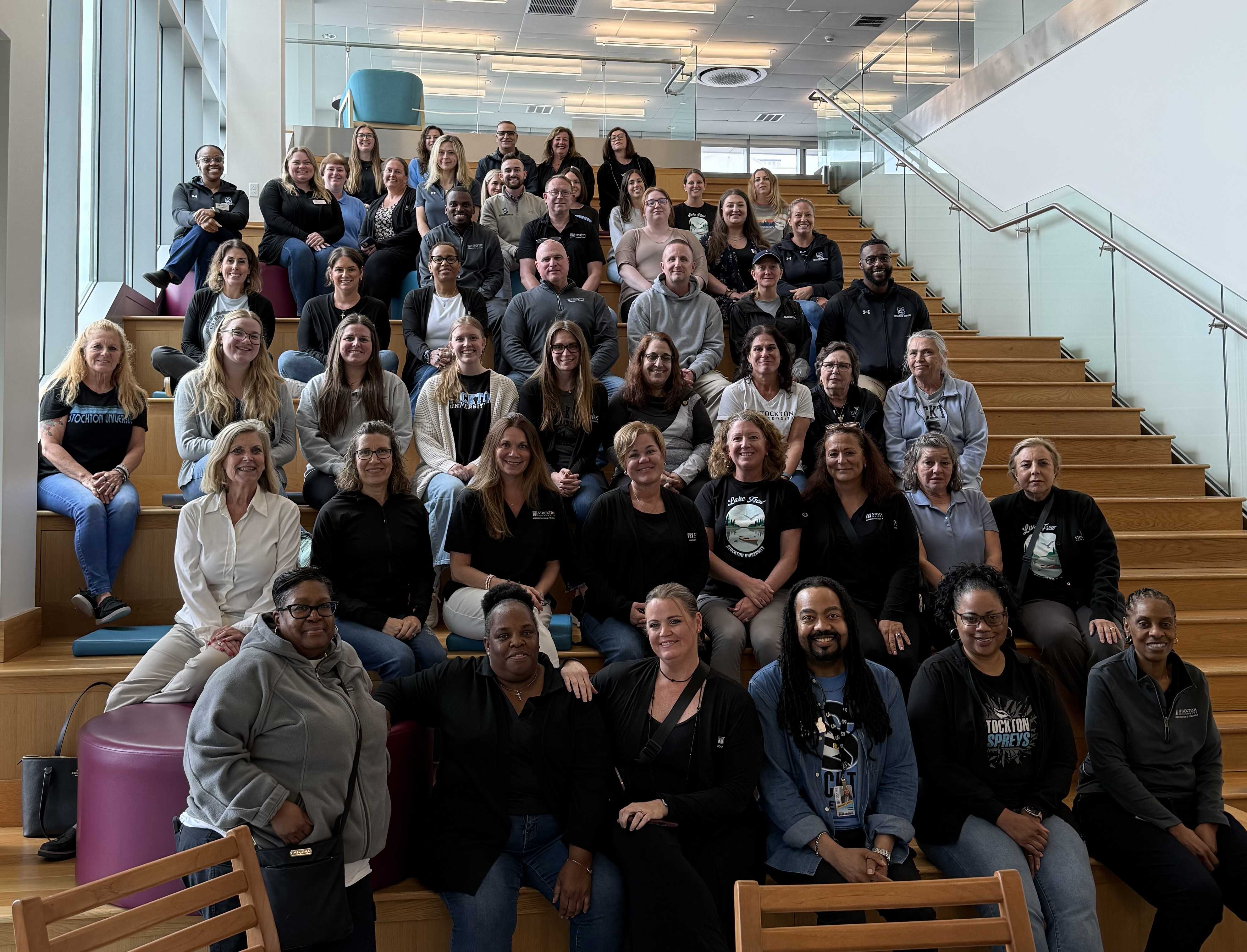 A&F team members smile sitting on stairs