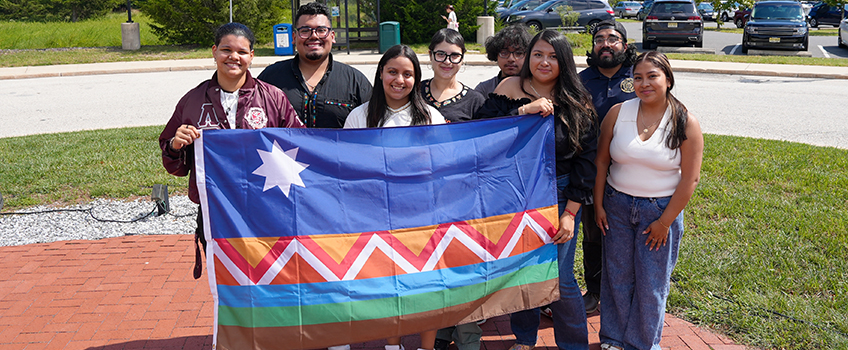 students holding hispanic heritage month flag