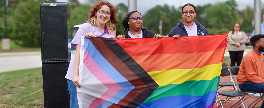 students with LGBTQ+ flag 