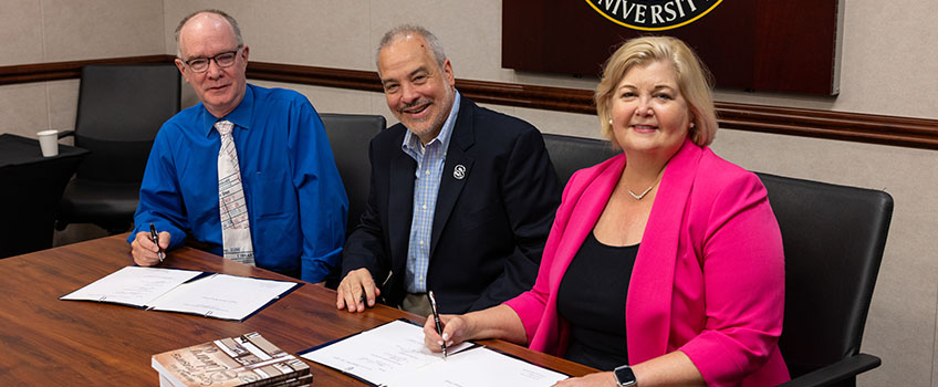 Tom Kinsella, left, makes donation