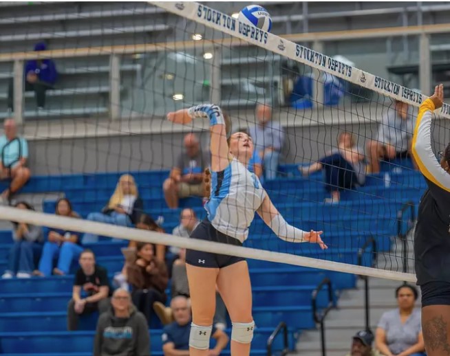 volleyball player spikes ball