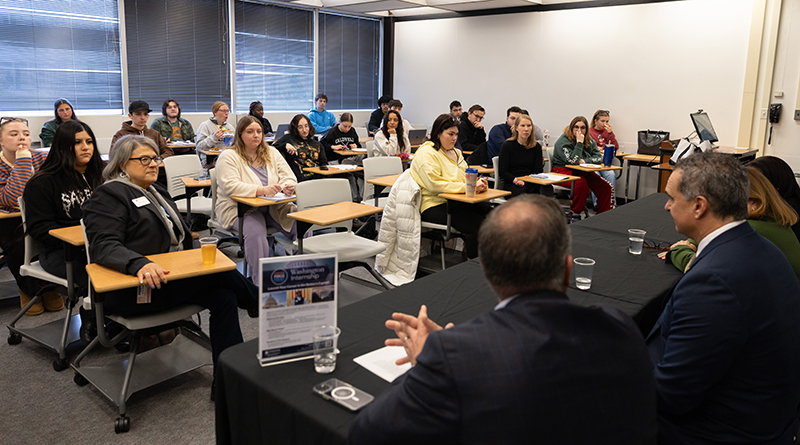 Students in an introductory politics class ask questions during a guest speaker session with local politicians.