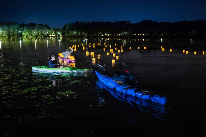 Paper lanterns with messages to loved ones lost to cancer float on Lake Fred under the moonlight during Kappa Sigma’s Light Up Lake Fred benefit for the Ulman Cancer Fund for Young Adults.