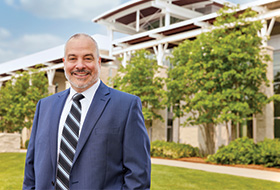 President Joe Bertolino in front of the Campus Center