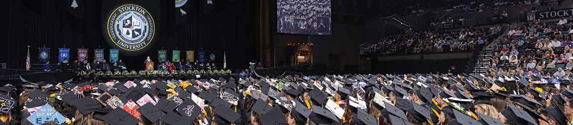 Stockton's Commencement stage with a sea of graduation caps in the foreground